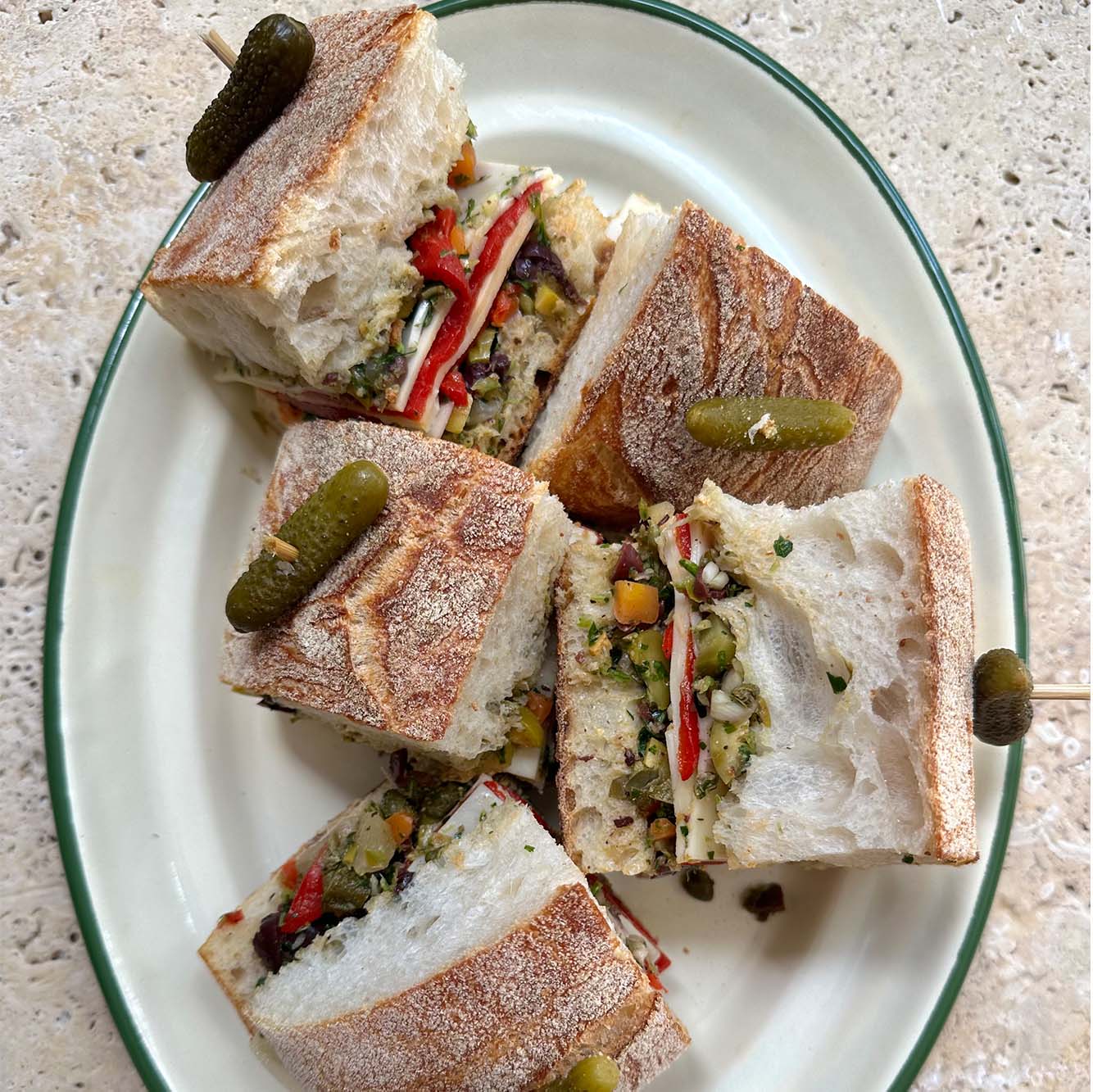 Muffaletta sandwich with provolone & marinated peppers